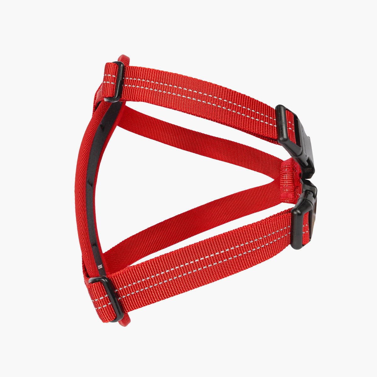 Red dog harness with black buckles on a white background