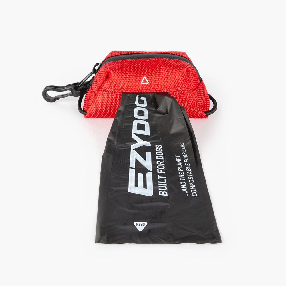 Red pet waste bag dispenser with black drawstring bag featuring 'EzyDog' branding on a white background.