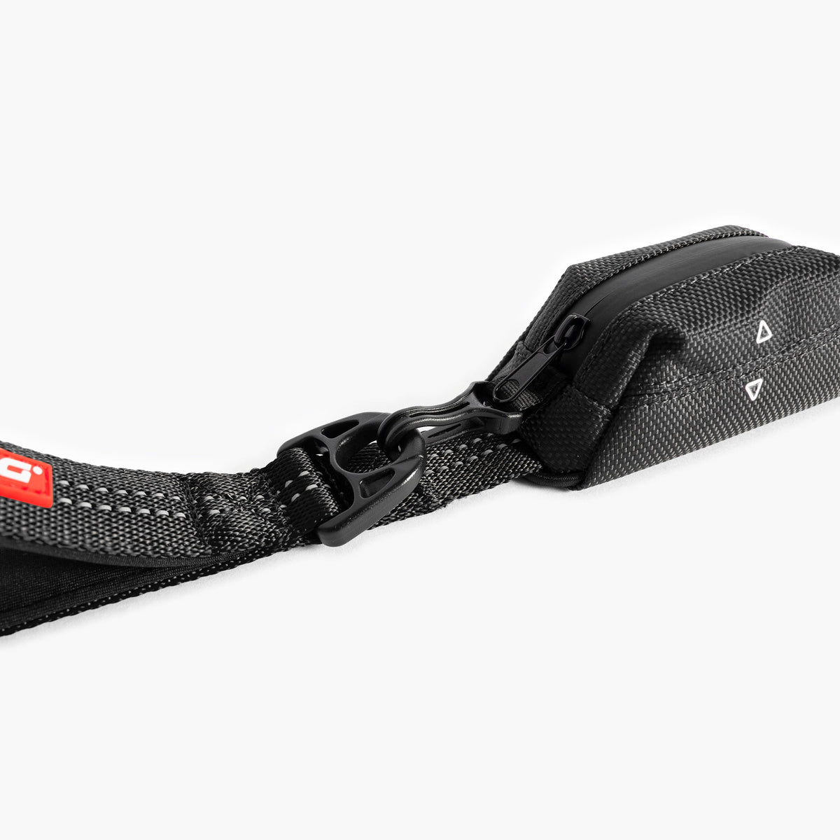 Black Essential Dog Poop Bag Holder strap with a red label on a white background
