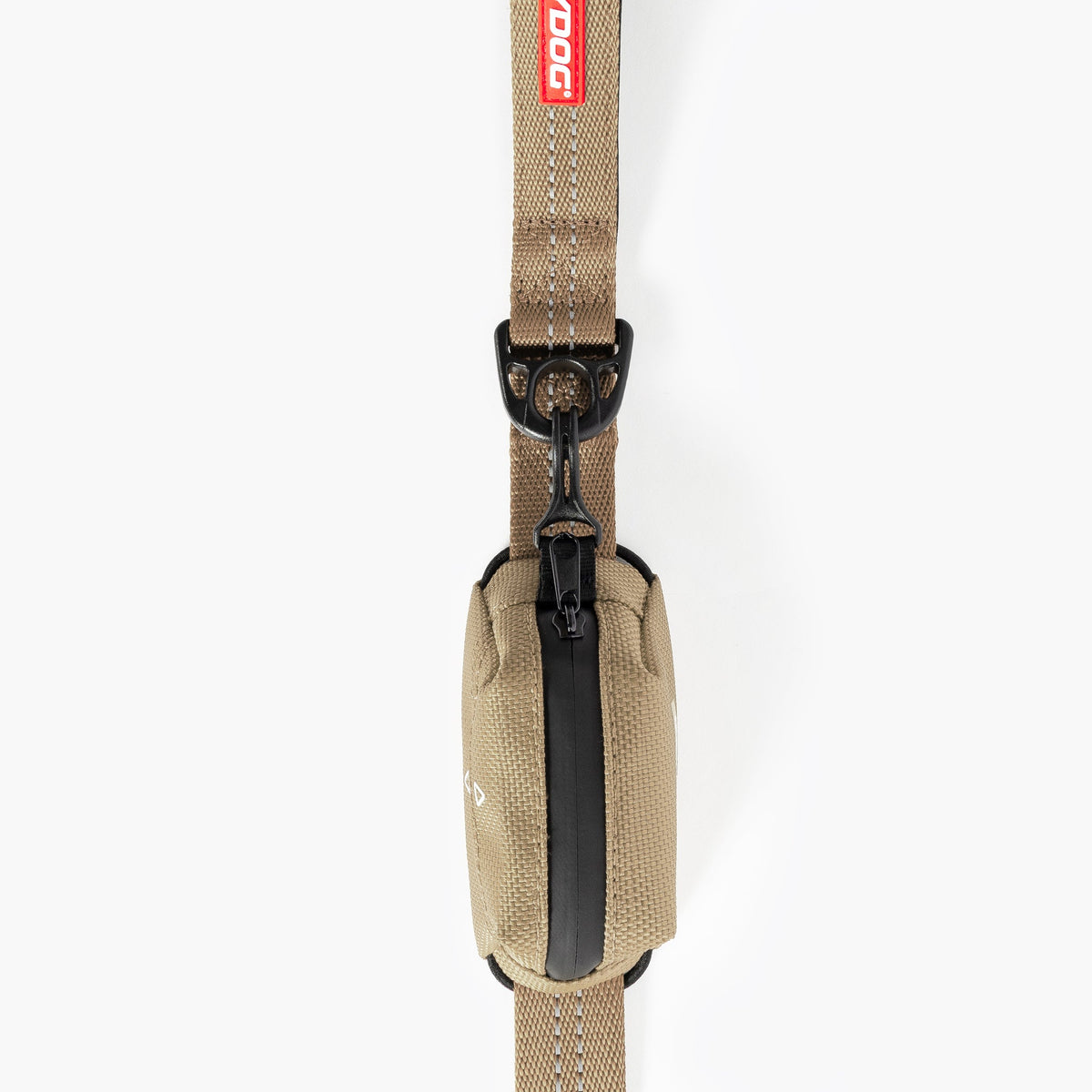 Tan sling bag with black strap on a white background