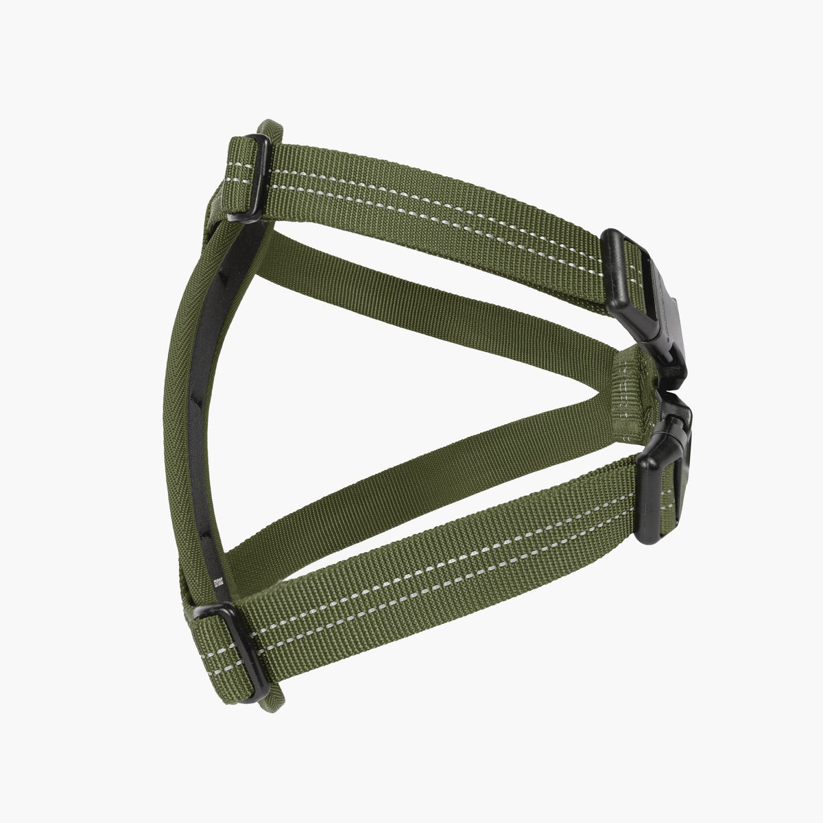 Green dog harness with black hardware on a white background