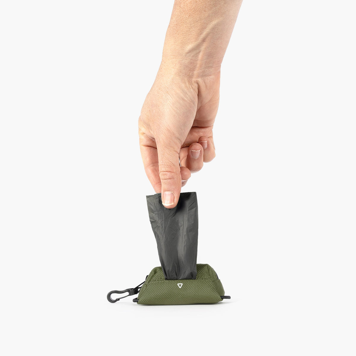 Hand holding a small green bag with a black component on a white background