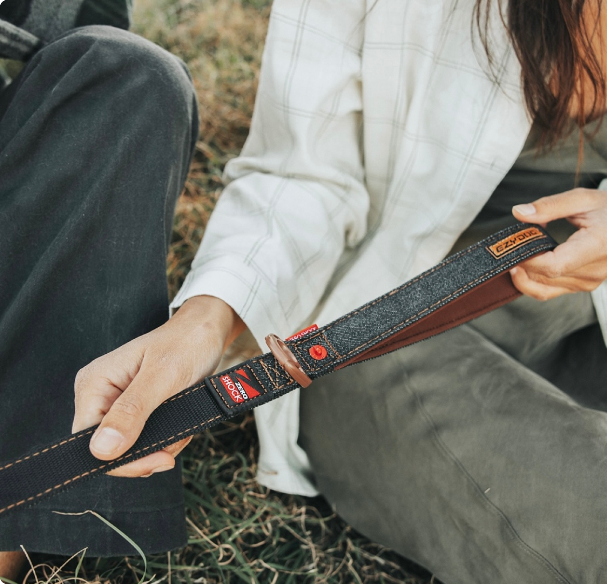 Close-up of a hand holding a premium black EzyDog leash.